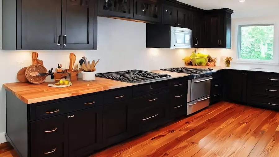 Designers share their best tips on how to choose and design a beautiful kitchen using black cabinets, granite and wood.